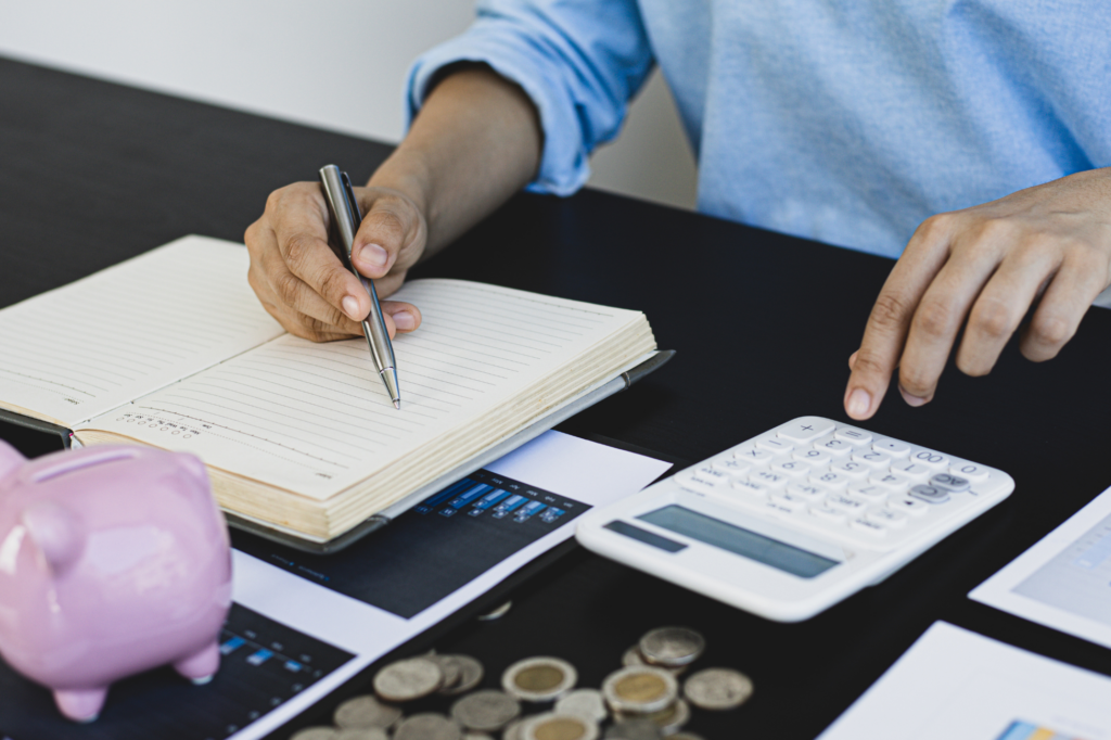 Image illustrating strategies for saving money on taxes, featuring charts, calculators, and tax documents.